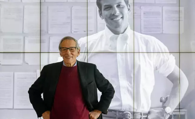 FILE - Author and biographer Robert Caro stands beside an image of his younger self after touring a permanent exhibit in his honor at the New York Historical Society Museum &amp; Library in New York on Oct. 20, 2021. (AP Photo/John Minchillo, File)