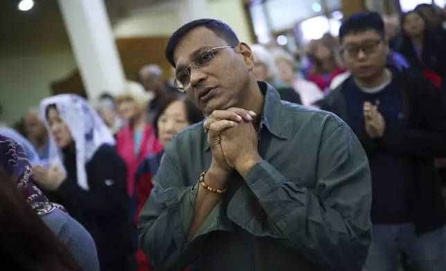 Pilgrims say their prayers inside the St. James Church in Medjugorje, Bosnia, Thursday, Sept. 19, 2024. (AP Photo/Armin Durgut)