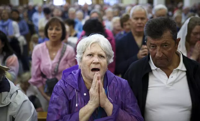 Pilgrims say their prayers inside the St. James Church in Medjugorje, Bosnia, Thursday, Sept. 19, 2024. (AP Photo/Armin Durgut)