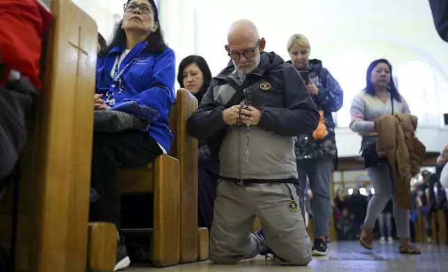 Pilgrims say their prayers inside the St. James Church in Medjugorje, Bosnia, Thursday, Sept. 19, 2024. (AP Photo/Armin Durgut)