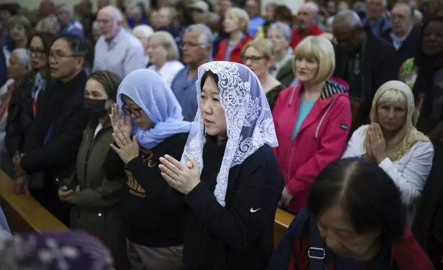 Pilgrims say their prayers inside the St. James Church in Medjugorje, Bosnia, Thursday, Sept. 19, 2024. (AP Photo/Armin Durgut)