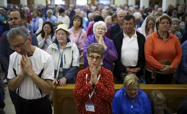 Pilgrims say their prayers inside the St. James Church in Medjugorje, Bosnia, Thursday, Sept. 19, 2024. (AP Photo/Armin Durgut)