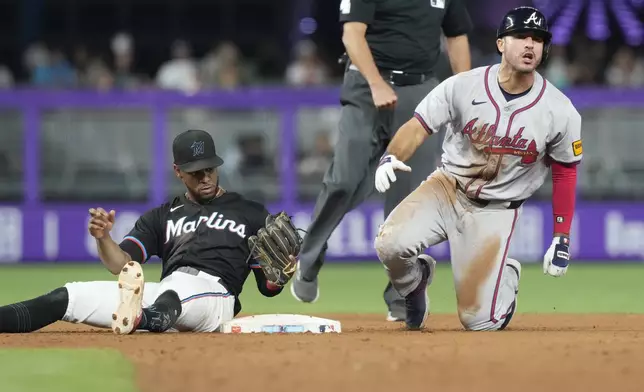 Atlanta Braves' Ramón Laureano reacts after he is tagged out by Miami Marlins second baseman Otto Lopez (61) during the eighth inning of a baseball game, Friday, Sept. 20, 2024, in Miami. (AP Photo/Marta Lavandier)