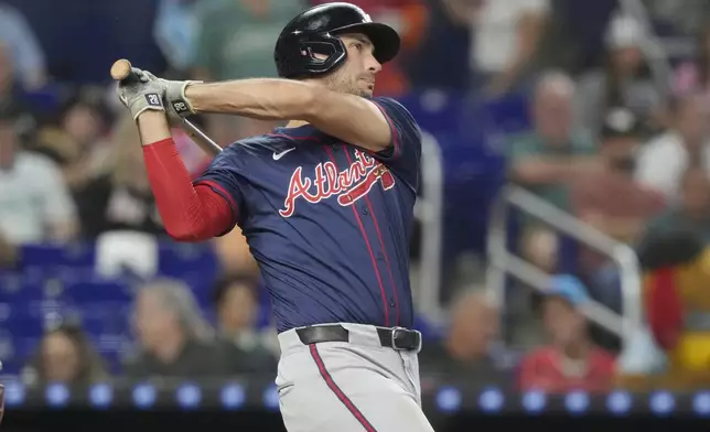 Atlanta Braves' Matt Olson hits a two-run home run during the seventh inning of a baseball game against the Miami Marlins, Saturday, Sept. 21, 2024, in Miami. (AP Photo/Marta Lavandier)