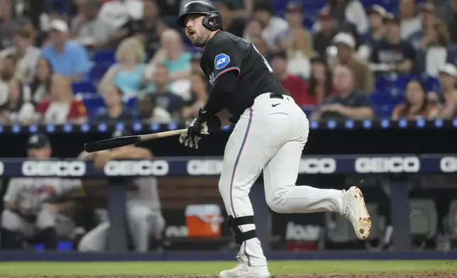 Miami Marlins' Jake Burger (36) hits a single to left field during the third inning of a baseball game against the Atlanta Braves, Friday, Sept. 20, 2024, in Miami. (AP Photo/Marta Lavandier)