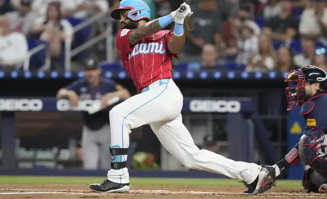 Miami Marlins' Derek Hill hits a triple during the first inning of a baseball game against the Atlanta Braves, Saturday, Sept. 21, 2024, in Miami. (AP Photo/Marta Lavandier)