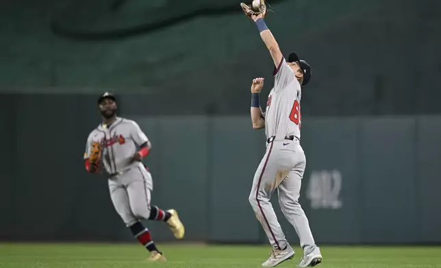 Atlanta Braves center fielder Michael Harris II, left, watches Braves second baseman Luke Williams catch a pop up fly ball by Washington Nationals' Keibert Ruiz for the second out of the sixth inning of a baseball game, Tuesday, Sept. 10, 2024, in Washington. (AP Photo/John McDonnell)