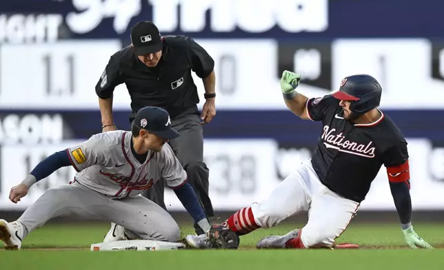 Atlanta Braves second baseman Cavan Biggio, left, tags out Washington Nationals' Juan Yepez attempting a double during the second inning of a baseball game, Wednesday, Sept. 11, 2024, in Washington. (AP Photo/John McDonnell)