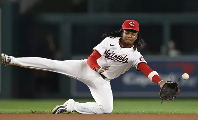 Washington Nationals shortstop CJ Abrams dives and misses Atlanta Braves Michael Harris II's single during the seventh inning of a baseball game, Tuesday, Sept. 10, 2024, in Washington. (AP Photo/John McDonnell)