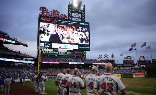 A tribute to Johnny and Matthew Gaudreau is seen before a baseball game between the Philadelphia Phillies and the Atlanta Braves, Friday, Aug. 30, 2024, in Philadelphia. (AP Photo/Matt Slocum)