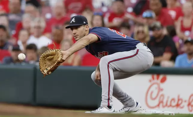 Atlanta Braves first baseman Matt Olson catches the ball to get Cincinnati Reds' Ty France out during the second inning of a baseball game, Wednesday, Sept. 18, 2024, in Cincinnati. (AP Photo/Jay LaPrete)