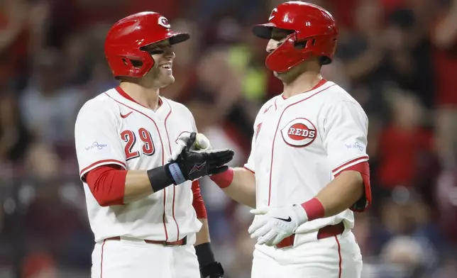 Cincinnati Reds' Spencer Steer, right, celebrates his home run against the Atlanta Braves with teammate TJ Friedl during the seventh inning of a baseball gam,e Tuesday, Sept. 17, 2024, in Cincinnati. (AP Photo/Jay LaPrete)