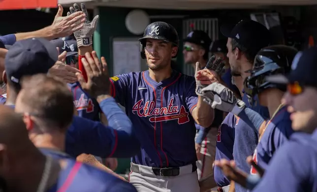 Atlanta Braves' Matt Olson, center, celebrates with teammates in the dugout after hitting a solo home run during the second inning of a baseball game against the Cincinnati Reds, Thursday, Sept. 19, 2024, in Cincinnati. (AP Photo/Joshua A. Bickel)