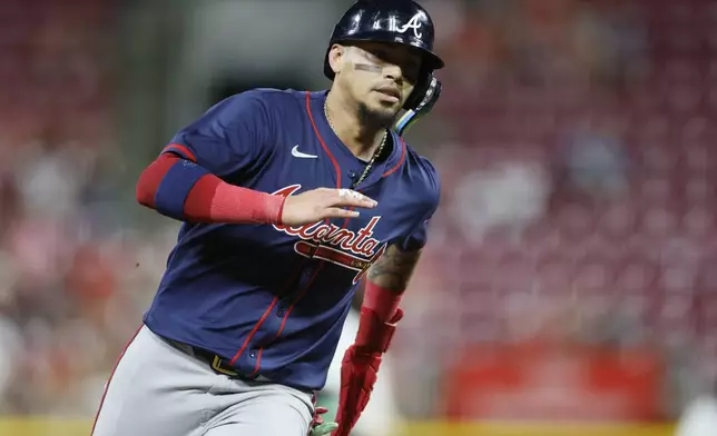 Atlanta Braves' Orlando Arcia scores from second base on a hit by teammate Gio Urshela against the Cincinnati Reds during the ninth inning of a baseball game, Wednesday, Sept. 18, 2024, in Cincinnati. (AP Photo/Jay LaPrete)