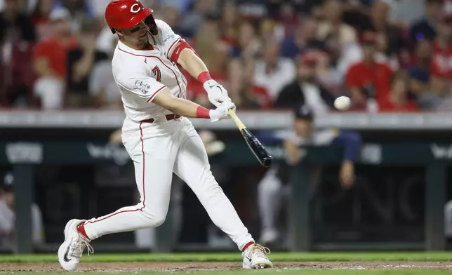 Cincinnati Reds' Spencer Steer hits a home run against the Atlanta Braves during the seventh inning of a baseball game, Tuesday, Sept. 17, 2024, in Cincinnati. (AP Photo/Jay LaPrete)