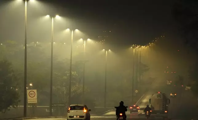 Smoke from a fire in the environmentally protected area of Brasilia National Park affects Brasilia, Brazil, before sunrise Monday, Sept. 16, 2024. The head of the agency that manages protected areas, Mauro Pires, told the local press that the fire is man-made and appears to have started near the edge of the presidency's official countryside residence. (AP Photo/Eraldo Peres)