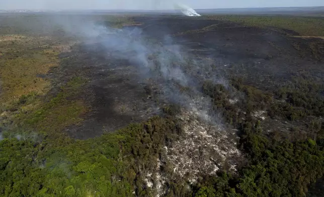 Smoke rises from fires in the environmentally protected area of Brasilia National Park during the dry season in Brasilia, Brazil, Monday, Sept. 16, 2024. The head of the agency that manages protected areas, Mauro Pires, told the local press that the fire was man-made and appears to have started near the edge of the presidency's official countryside residence. (AP Photo/Eraldo Peres)