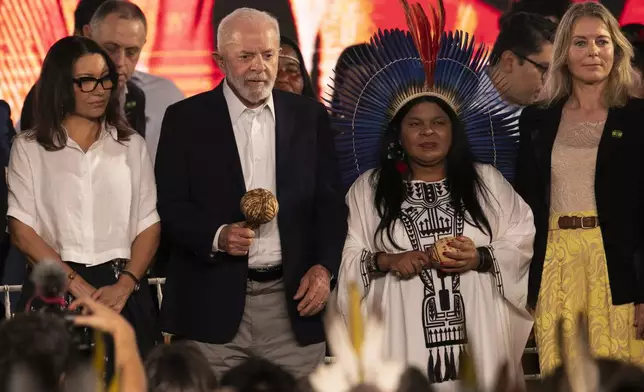 Brazil's President Luiz Inacio Lula da Silva, second from left, Minister for Indigenous Peoples Sonia Guajajara, second from right, and Denmark's Ambassador to Brazil Eva Bisgaard Pederson, right, attend a ceremony celebrating the return of the Indigenous Tupinamba people's sacred cloak to Brazil, in Rio de Janeiro, Thursday, Sept. 12, 2024. The garment, made from bird feathers and plant fibers, was repatriated to Brazil after having spent more than 300 years in the National Museum of Denmark. (AP Photo/Bruna Prado)