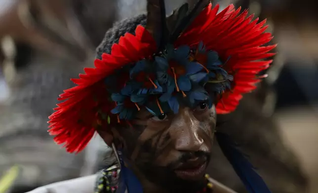 An Indigenous person attends a ceremony celebrating the return of the Tupinamba Indigenous people's sacred cloak to Brazil, in Rio de Janeiro, Thursday, Sept. 12, 2024. The garment, made from bird feathers and plant fibers, was repatriated to Brazil after having spent more than 300 years in the National Museum of Denmark. (AP Photo/Bruna Prado)