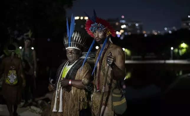 Indigenous people pose for a photo after a ceremony celebrating the return of the Indigenous Tupinamba people's sacred cloak to Brazil, in Rio de Janeiro, Thursday, Sept. 12, 2024. The garment, made from bird feathers and plant fibers, was repatriated to Brazil after having spent more than 300 years in the National Museum of Denmark. (AP Photo/Bruna Prado)