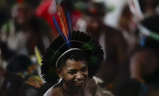 An Indigenous person smiles before a ceremony celebrating the return of the Indigenous Tupinamba people's sacred cloak to Brazil, in Rio de Janeiro, Thursday, Sept. 12, 2024. The garment, made from bird feathers and plant fibers, was repatriated to Brazil after having spent more than 300 years in the National Museum of Denmark. (AP Photo/Bruna Prado)