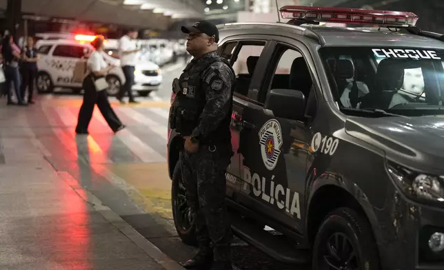 A policeman stands guard during the arrival of the Green Bay Packers at Sao Paulo International airport ahead of a game against the Philadelphia Eagles, in Guarulhos, greater Sao Paulo, Brazil Wednesday, Sept. 4, 2024. (AP Photo/Andre Penner)