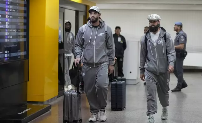 The Philadelphia Eagles' Dallas Goedert, left, and teammates arrive at Sao Paulo International airport in Guarulhos, greater Sao Paulo, Brazil, Wednesday, Sept. 4, 2024. (AP Photo/Andre Penner)