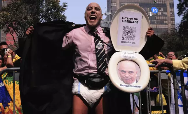 A protester, dressed to depict Supreme Court Minister Alexandre de Moraes wearing a diaper, takes part in a protest calling for the impeachment of de Moraes, who recently imposed a nationwide block on Elon Musk's social media platform X, in Sao Paulo, Saturday, Sept. 7, 2024. (AP Photo/Ettore Chiereguini)