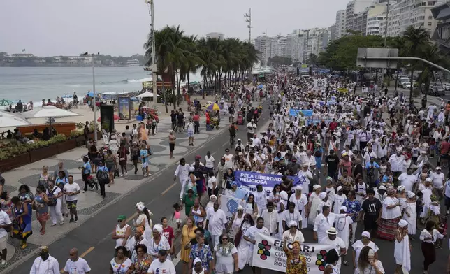 Faithful from various religions participate in the Defense of Religious Freedom march at Copacabana beach in Rio de Janeiro, Sunday, Sept. 15, 2024. The march seeks to bring attention to religious intolerance in the country. (AP Photo/Silvia Izquierdo)