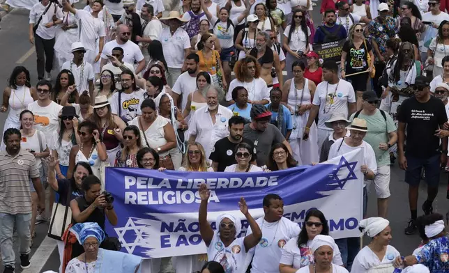 Faithful from various religions participate in the Defense of Religious Freedom march at Copacabana beach in Rio de Janeiro, Sunday, Sept. 15, 2024. The march seeks to bring attention to religious intolerance in the country. (AP Photo/Silvia Izquierdo)