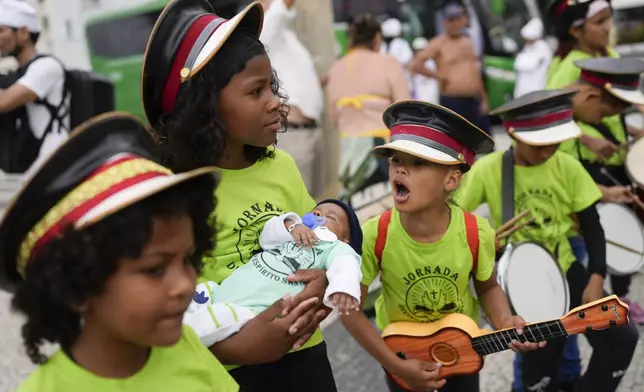 Youth participate in a Defense of Religious Freedom march at Copacabana beach in Rio de Janeiro, Sunday, Sept. 15, 2024. The march seeks to bring attention to religious intolerance in the country. (AP Photo/Silvia Izquierdo)