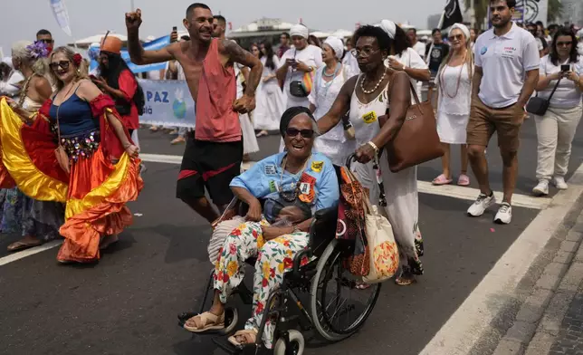 Faithful from various religions participate in the Defense of Religious Freedom march at Copacabana beach in Rio de Janeiro, Sunday, Sept. 15, 2024. The march seeks to bring attention to religious intolerance in the country. (AP Photo/Silvia Izquierdo)