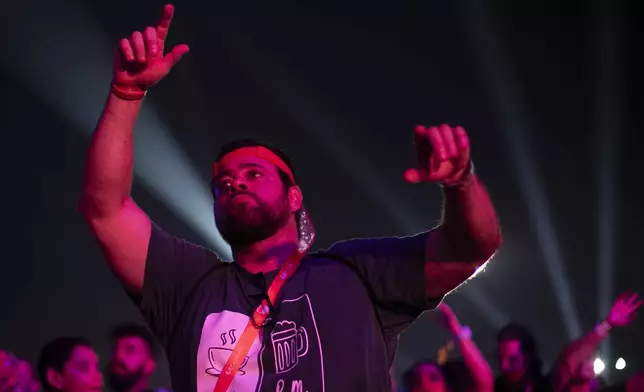 Diogo Soares Abdulmassih, 48, who is deaf people, watches Brazilian singer Zeca Baleiro performs at the Rock in Rio music festival in Rio de Janeiro, Saturday, Sept. 21, 2024. (AP Photo/Bruna Prado)