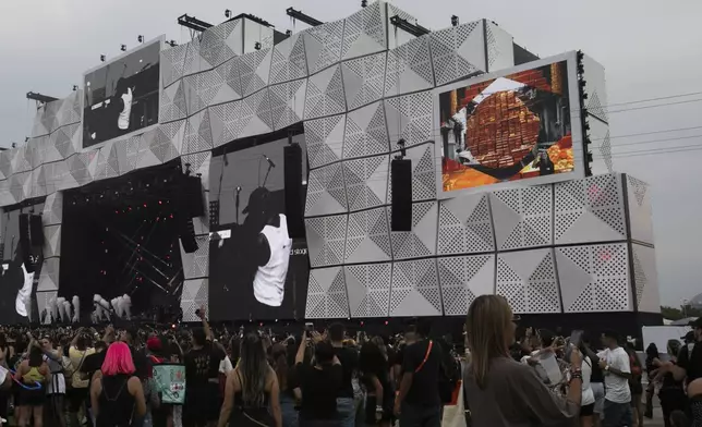 Sign language interpreter, top right, translates on a big screen during a performance by Brazilian singer Kayblack at the Rock in Rio music festival in Rio de Janeiro, Saturday, Sept. 21, 2024. (AP Photo/Bruna Prado)