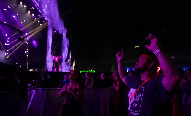 Diogo Soares Abdulmassih, 48, who is deaf, watches Brazilian singer Zeca Baleiro perform at the Rock in Rio music festival in Rio de Janeiro, Saturday, Sept. 21, 2024. (AP Photo/Bruna Prado)