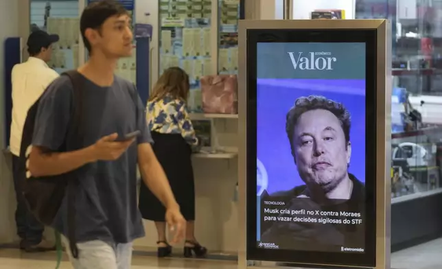 An ad by Valor media shows a photo of Elon Musk at a shopping center in Brasilia, Brazil, Monday, Sept. 2, 2024. The sign reads in Portuguese: "Musk creates profile on X against Moraes to leak confidential decisions of the Supreme Court," referring to Supreme Court Justice Alexandre de Moraes who ordered the platform blocked for having failed to name a local legal representative as required by law. (AP Photo/Eraldo Peres)