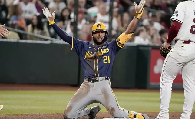 Milwaukee Brewers' Jackson Chourio (21) celebrates after his triple that scored two runs against the Arizona Diamondbacks during the 10th inning of a baseball game, Sunday, Sept. 15, 2024, in Phoenix. (AP Photo/Darryl Webb)