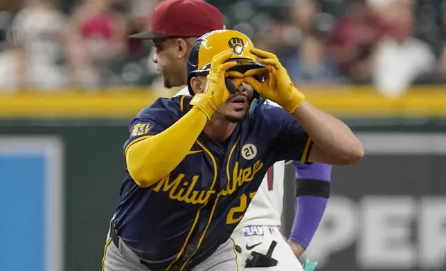 Milwaukee Brewers' Willy Adames gestures towards his dugout after hitting a double against the Arizona Diamondbacks during the sixth inning of a baseball game, Sunday, Sept. 15, 2024, in Phoenix. (AP Photo/Darryl Webb)