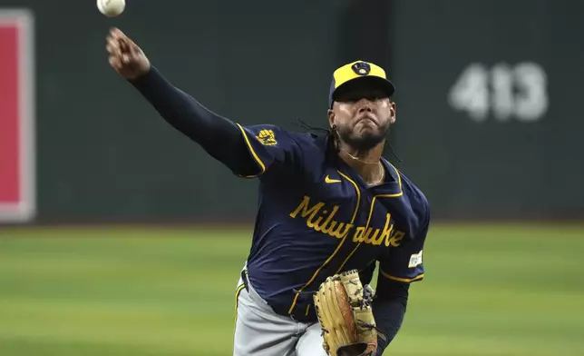 Milwaukee Brewers pitcher Freddy Peralta throws against the Arizona Diamondbacks in the first inning during a baseball game, Friday, Sept. 13, 2024, in Phoenix. (AP Photo/Rick Scuteri)