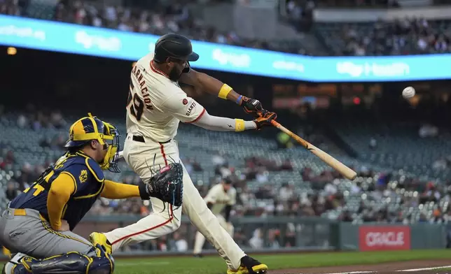 San Francisco Giants' Jerar Encarnacion hits a two-run home run during the first inning of a baseball game against the Milwaukee Brewers, Wednesday, Sept. 11, 2024, in San Francisco. (AP Photo/Godofredo A. Vásquez)