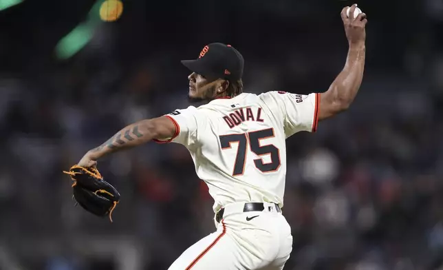 San Francisco Giants pitcher Camilo Doval throws to a Milwaukee Brewers batter during the seventh inning of a a baseball game in San Francisco, Thursday, Sept. 12, 2024. (AP Photo/Kavin Mistry)