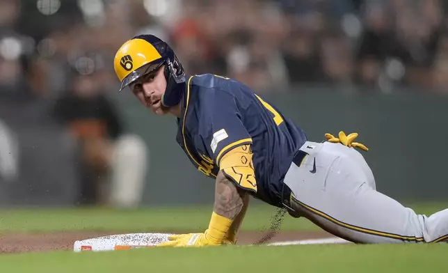 Milwaukee Brewers' Joey Ortiz slides into third base after hitting a triple against the San Francisco Giants during the seventh inning of a baseball game Tuesday, Sept. 10, 2024, in San Francisco. (AP Photo/Tony Avelar)