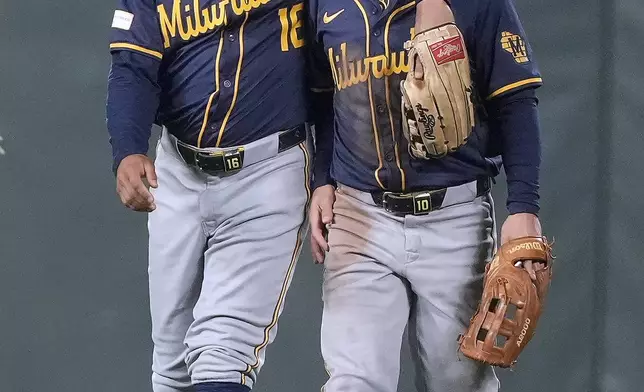 Milwaukee Brewers' Blake Perkins (16) hugs teammate Sal Frelick, right, after a victory against the San Francisco Giants in a baseball game, Tuesday, Sept. 10, 2024, in San Francisco. (AP Photo/Tony Avelar)