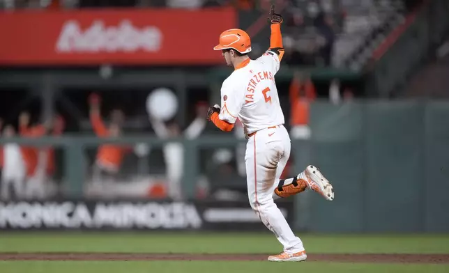 San Francisco Giants' Mike Yastrzemski gestures as he rounds the bases after hitting a solo home run against the Milwaukee Brewers during the sixth inning of a baseball game, Tuesday, Sept. 10, 2024, in San Francisco. (AP Photo/Tony Avelar)