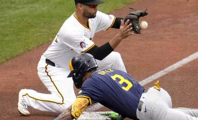 Milwaukee Brewers' Joey Ortiz (3) slides safely into third ahead of the relay throw to Pittsburgh Pirates third baseman Isiah Kiner-Falefa with a triple off starting pitcher Mitch Keller during the third inning of a baseball game in Pittsburgh, Thursday, Sept. 26, 2024. (AP Photo/Gene J. Puskar)