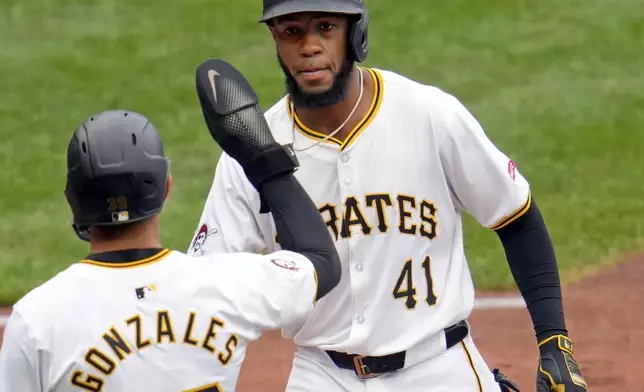 Pittsburgh Pirates' Bryan De La Cruz (41) is greeted by Nick Gonzales after hitting a two-run home run off Milwaukee Brewers relief pitcher Nick Mears during the seventh inning of a baseball game in Pittsburgh, Thursday, Sept. 26, 2024. (AP Photo/Gene J. Puskar)