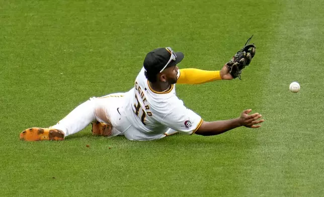 Pittsburgh Pirates shortstop Liover Peguero has a double hit by Milwaukee Brewers' Joey Ortiz bounce off his glove during the sixth inning of a baseball game in Pittsburgh, Thursday, Sept. 26, 2024. (AP Photo/Gene J. Puskar)