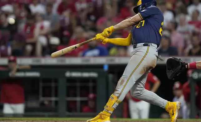 Milwaukee Brewers' Willy Adames hits a three-run home run during the third inning of a baseball game against the Cincinnati Reds, Saturday, Aug. 31, 2024, in Cincinnati. (AP Photo/Carolyn Kaster)