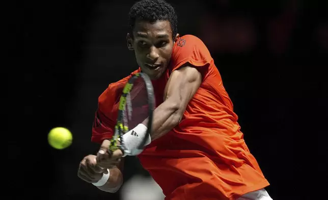 Canada's Felix Auger Aliassime returns the ball to Argentina's Sebastian Baez during the Davis Cup group stage finals match in Manchester, England, Tuesday Sept. 10, 2024. (Martin Rickett/PA via AP)