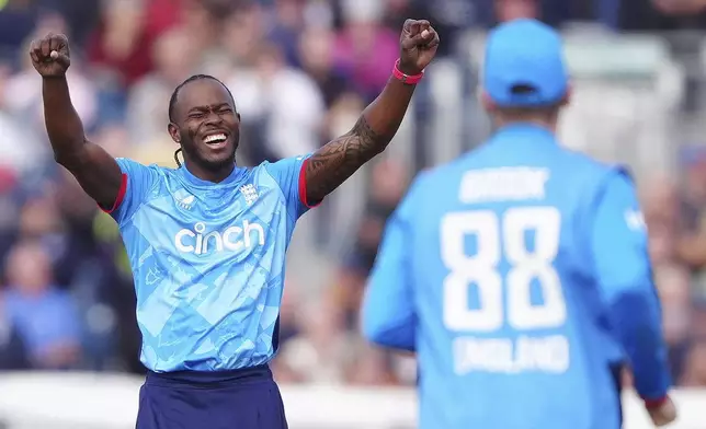 England's Jofra Archer, left, celebrates taking the wicket of Australia's Steven Smith during the third one day international cricket match between England and Australia in County Durham, England, Tuesday, Sept. 24, 2024. (Owen Humphreys/PA via AP)